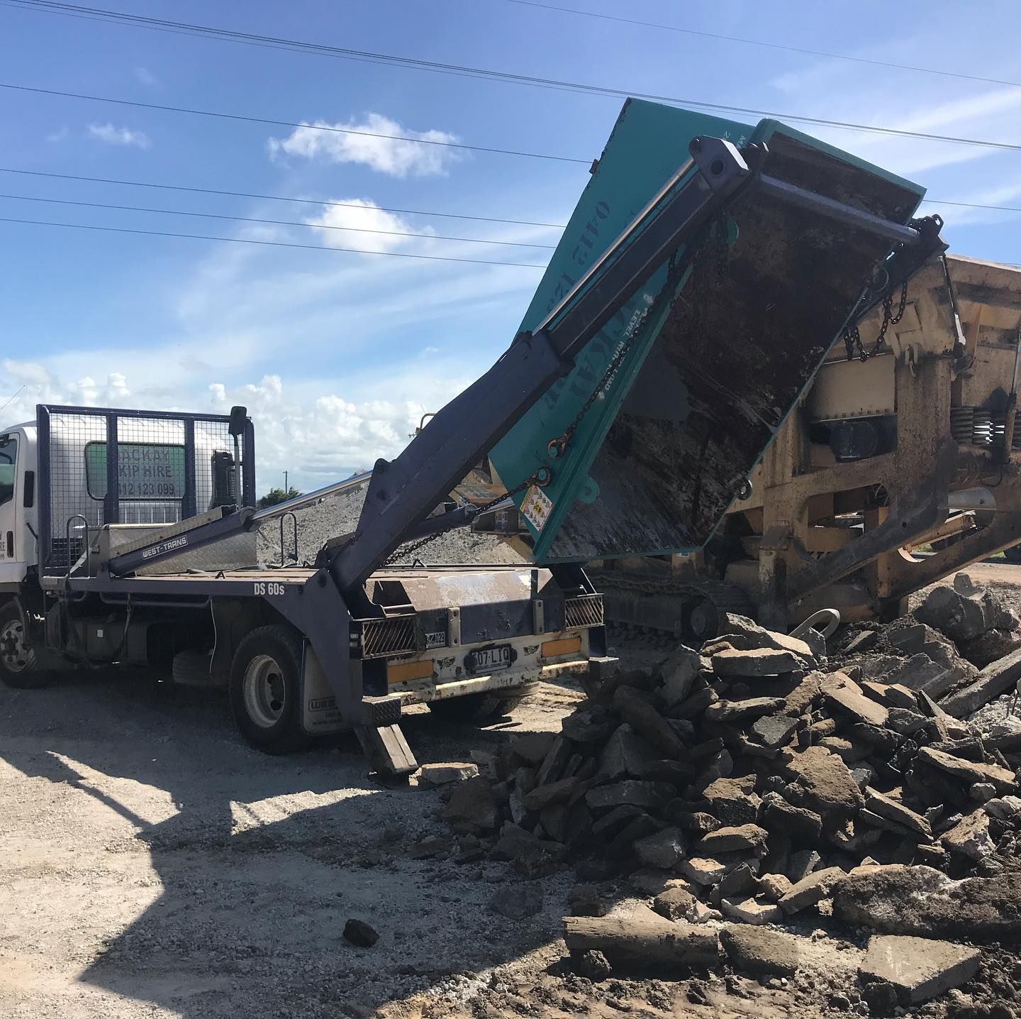 A Full Yellow Dumpster Overflowing With Brick and Debris — Mackay Skip Hire In Andergrove, QLD