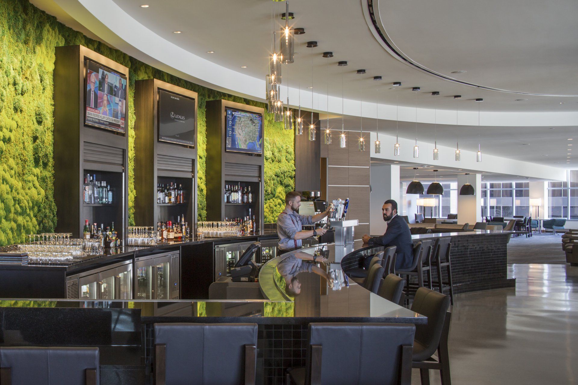 A group of people are sitting at a bar in a restaurant.