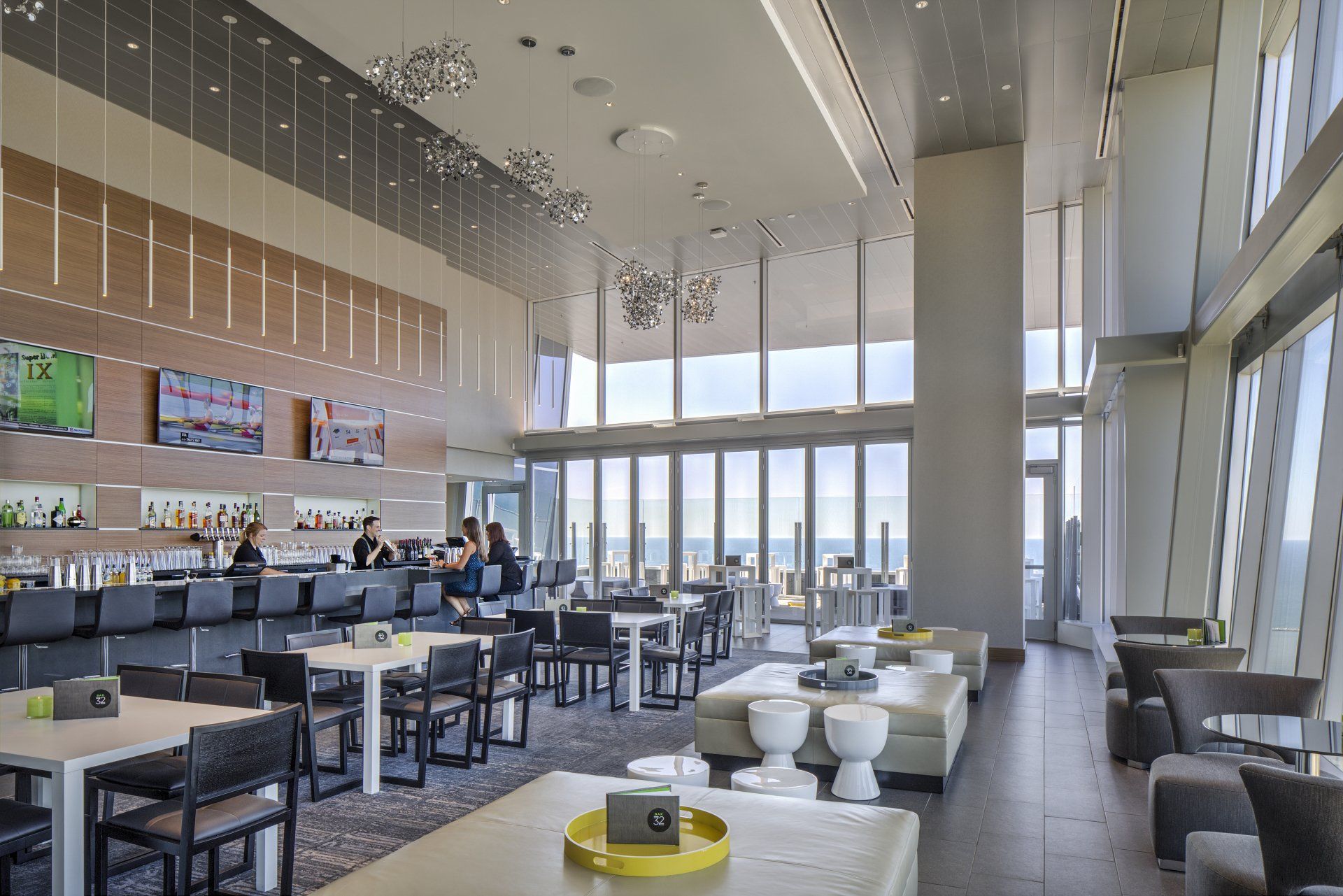 A large room with tables and chairs and a bar