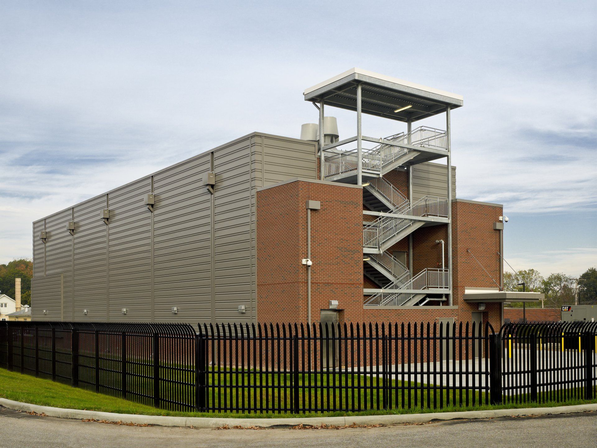 A large building with stairs and a fence around it