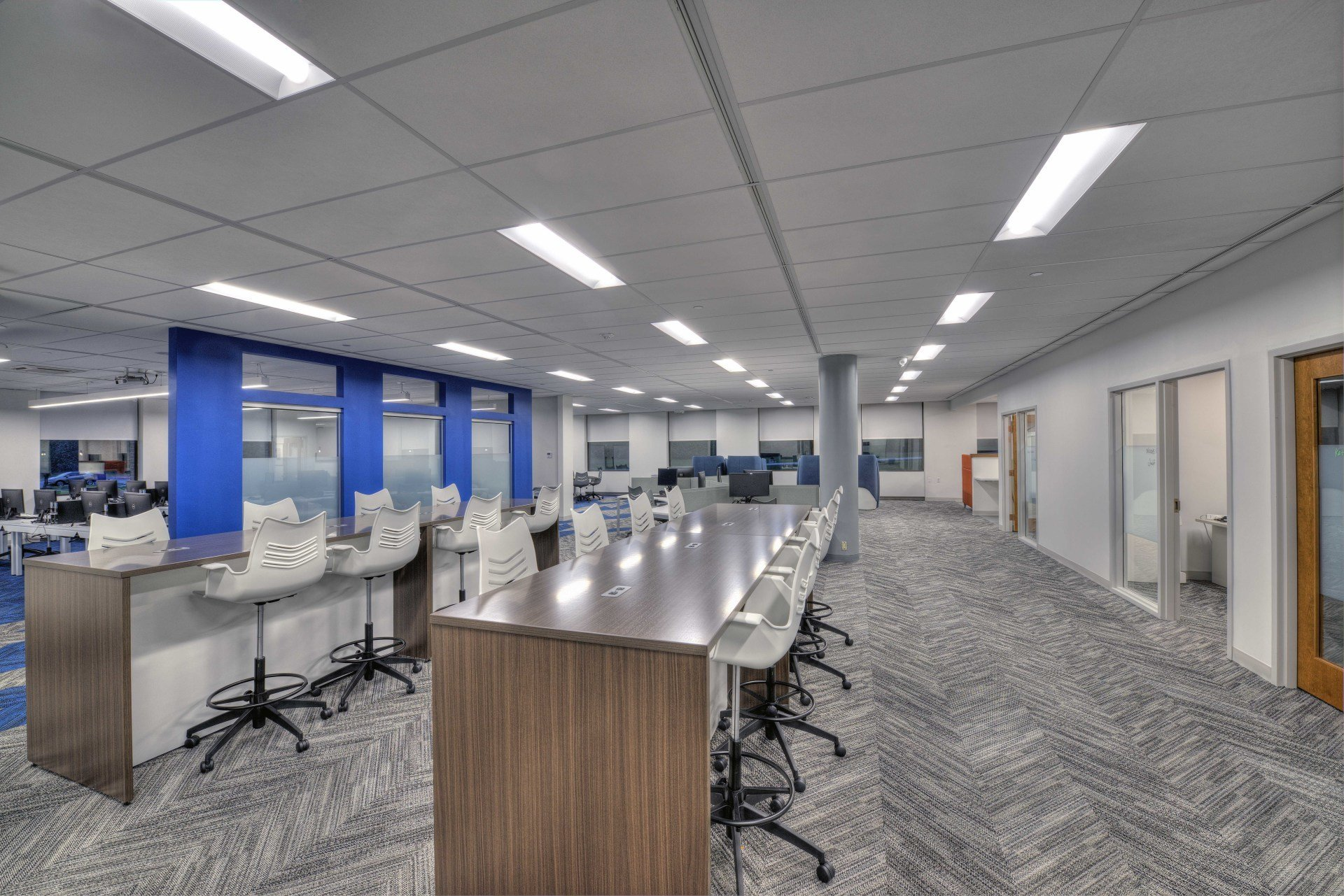 A large room with a long table and chairs in it.