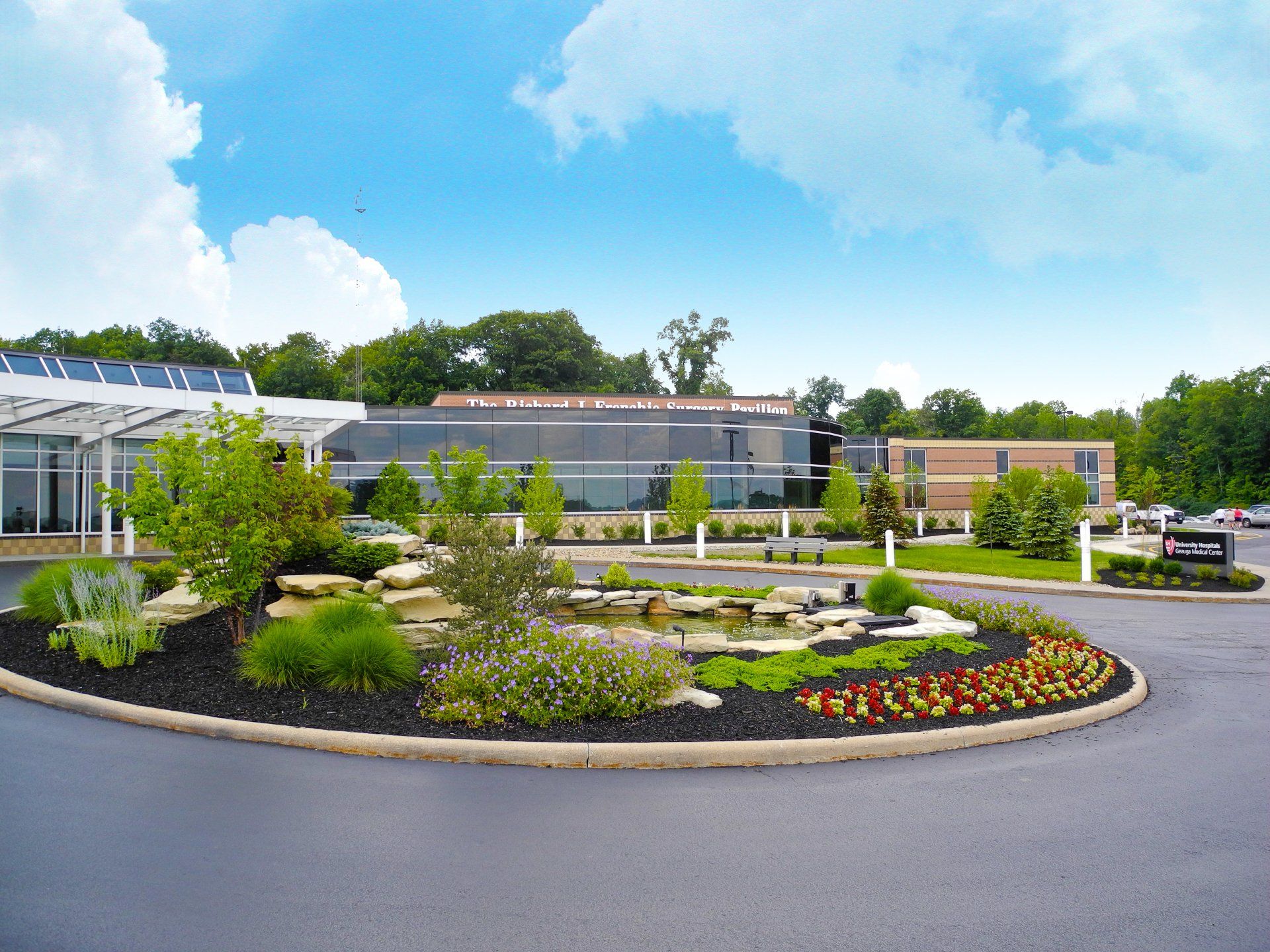 A large building with a circular garden in front of it