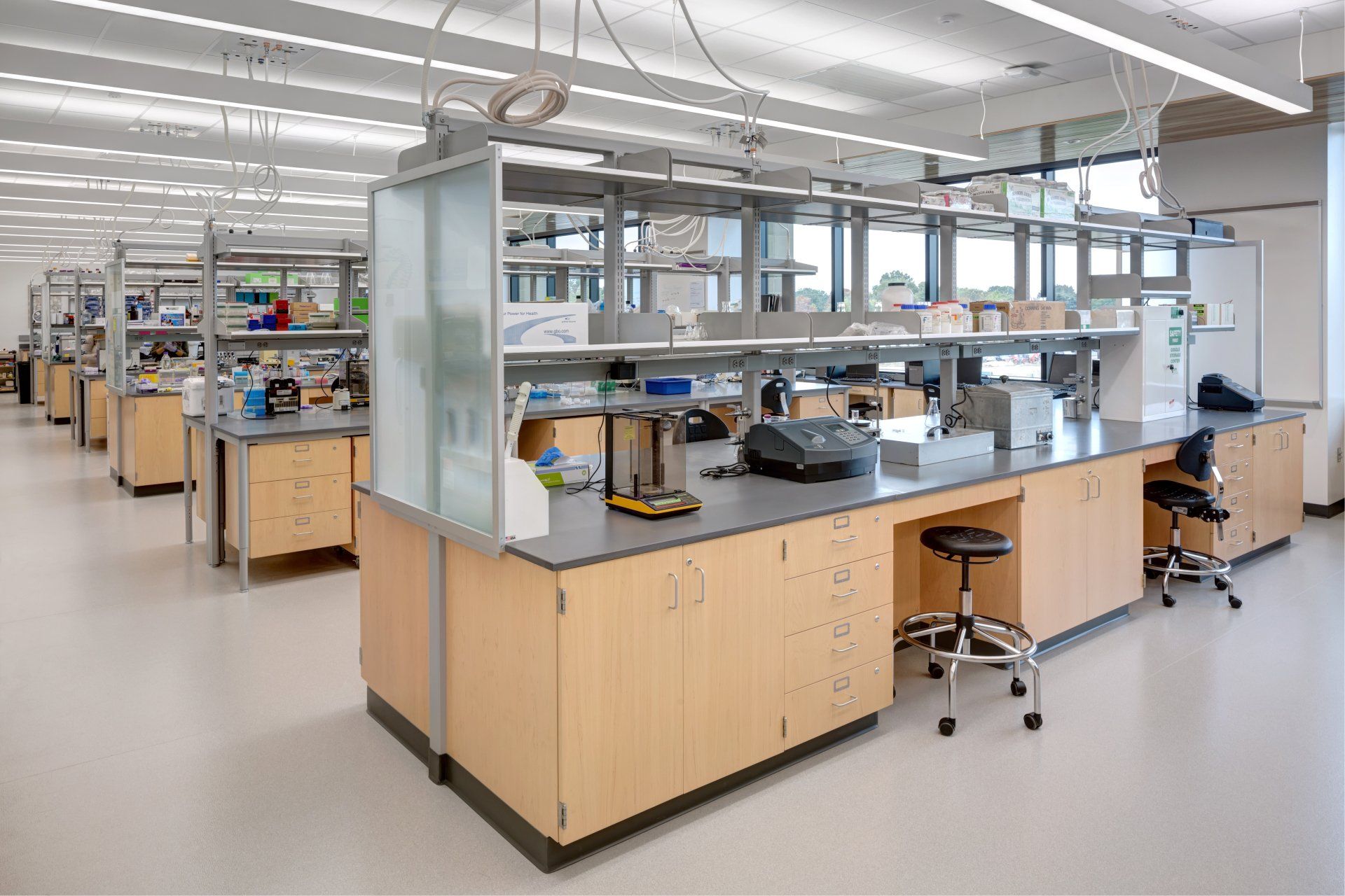 A large empty laboratory with a lot of tables and shelves.