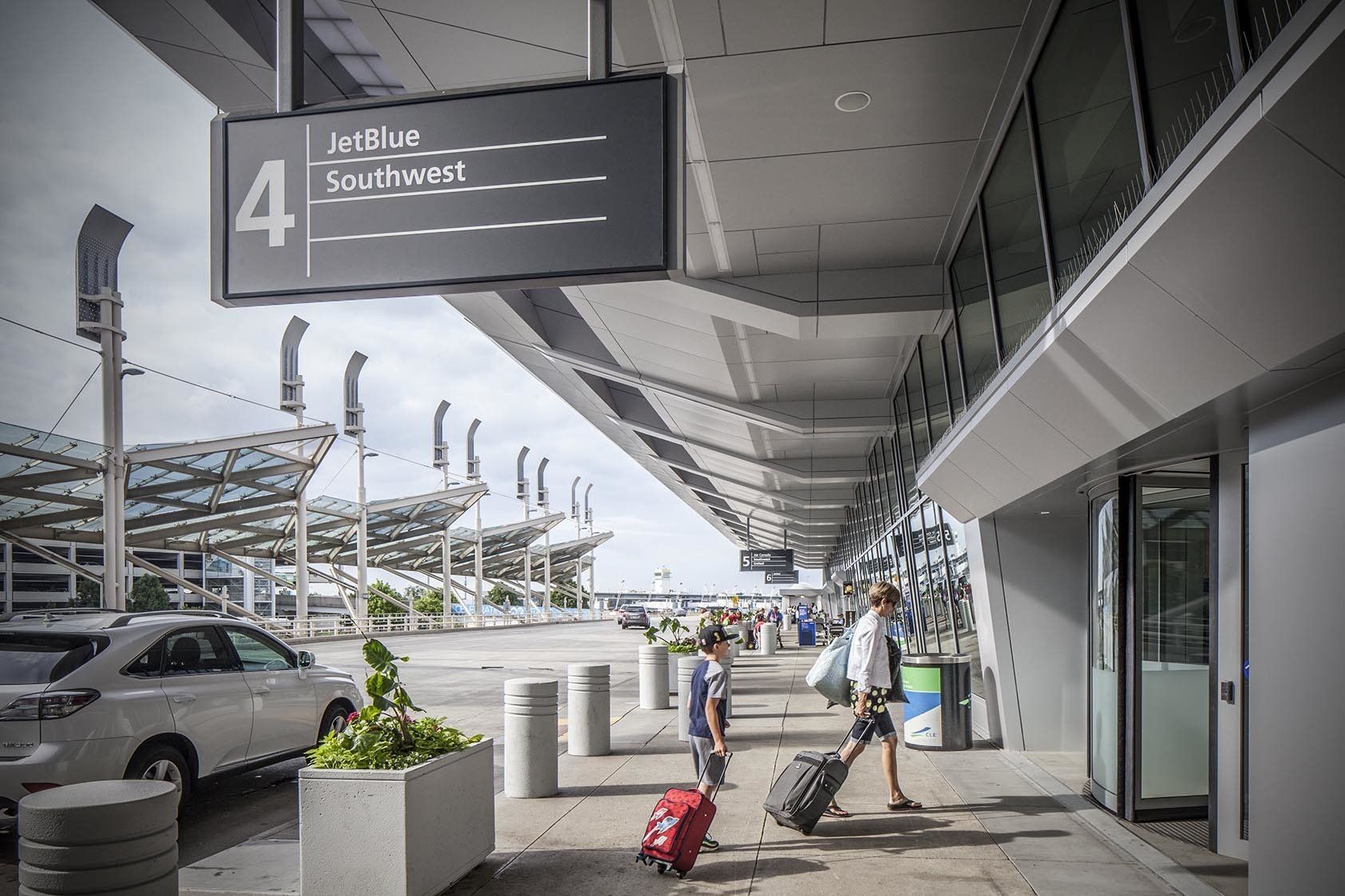 A person is pulling a suitcase through an airport.