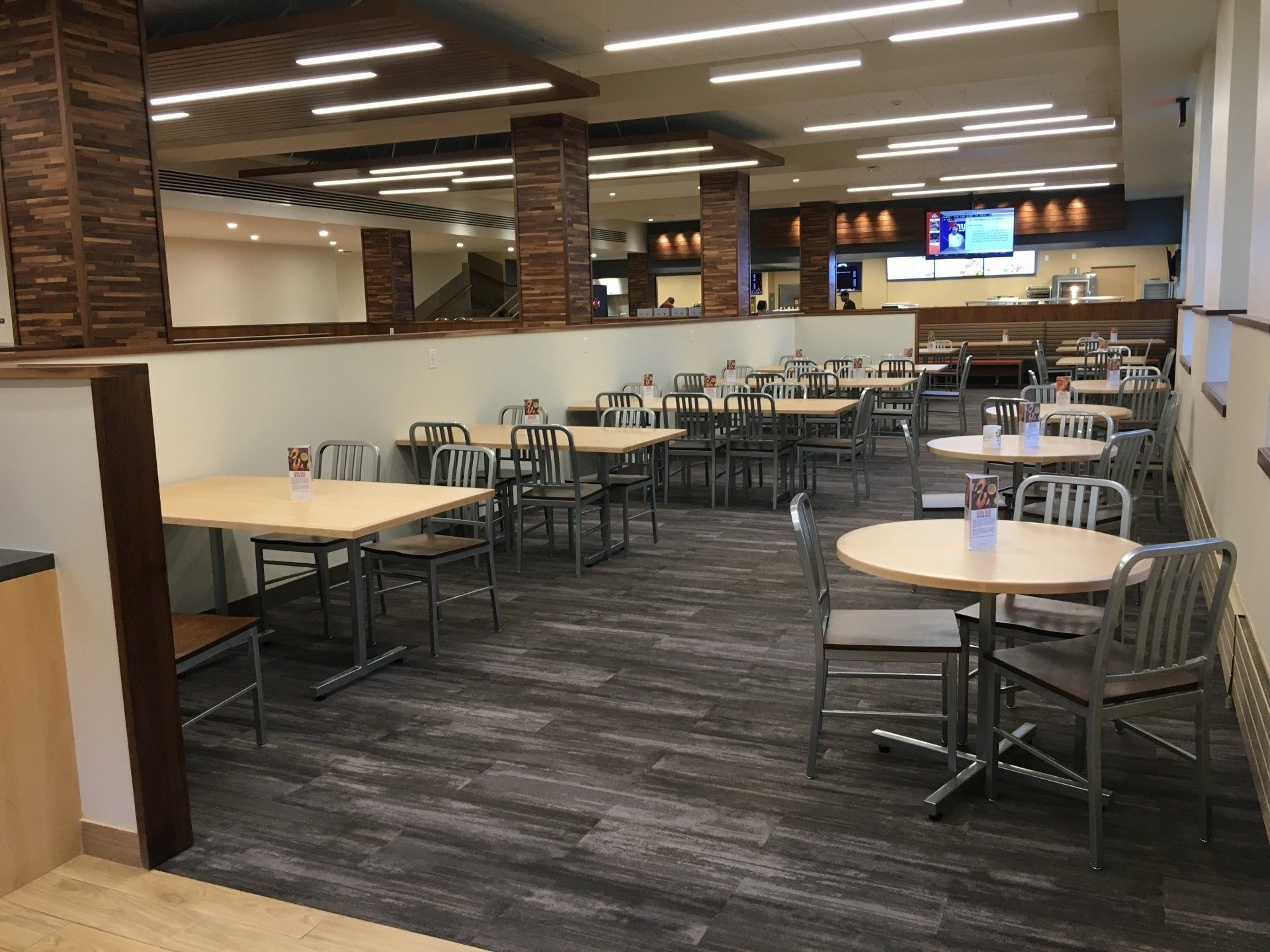 A large dining room with tables and chairs in a restaurant.