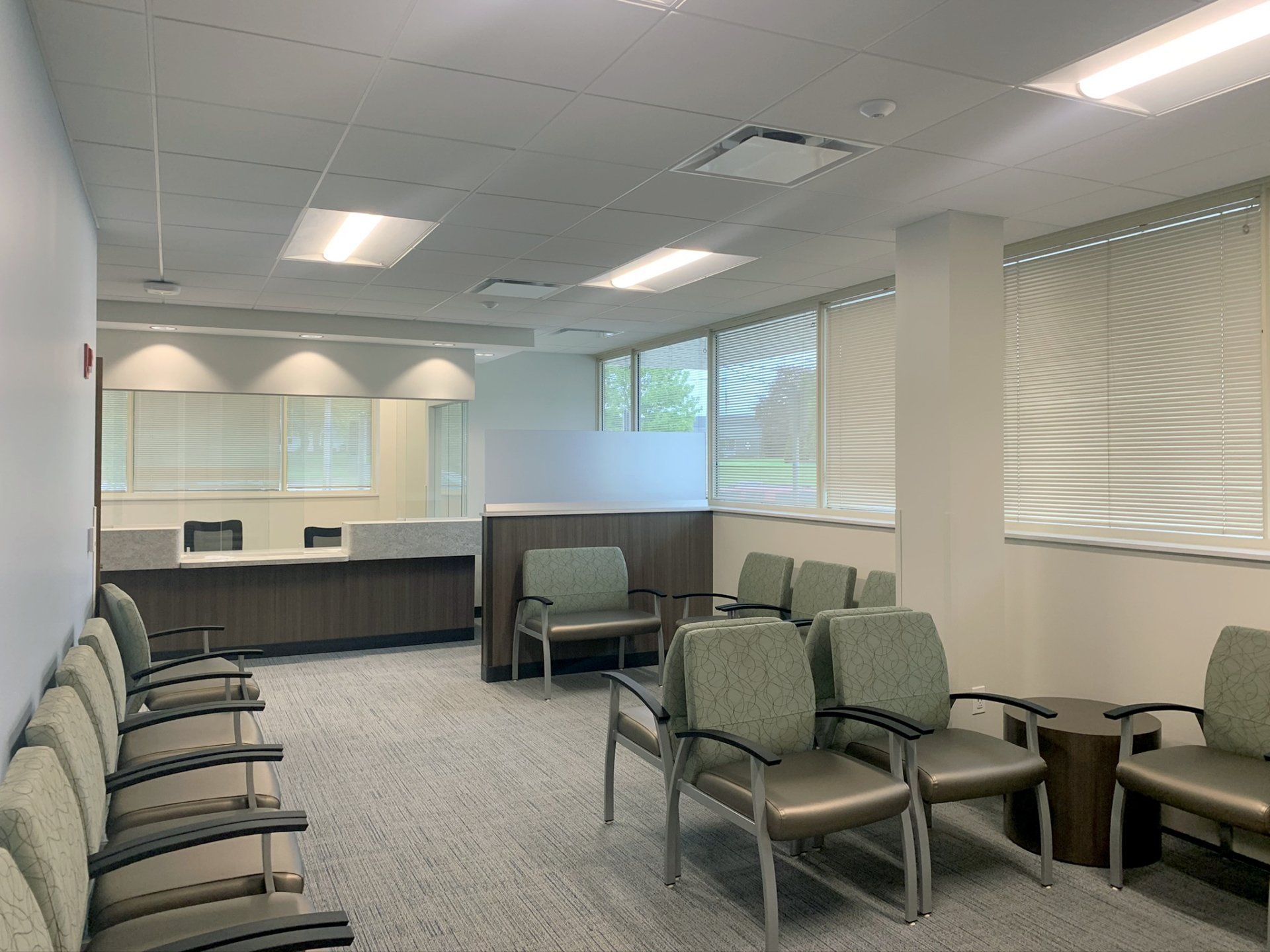 A waiting room with a lot of chairs and a counter.