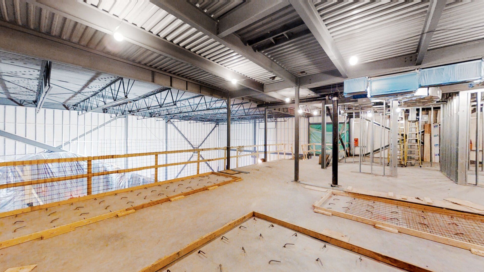 A large empty room with a ceiling that is being built.