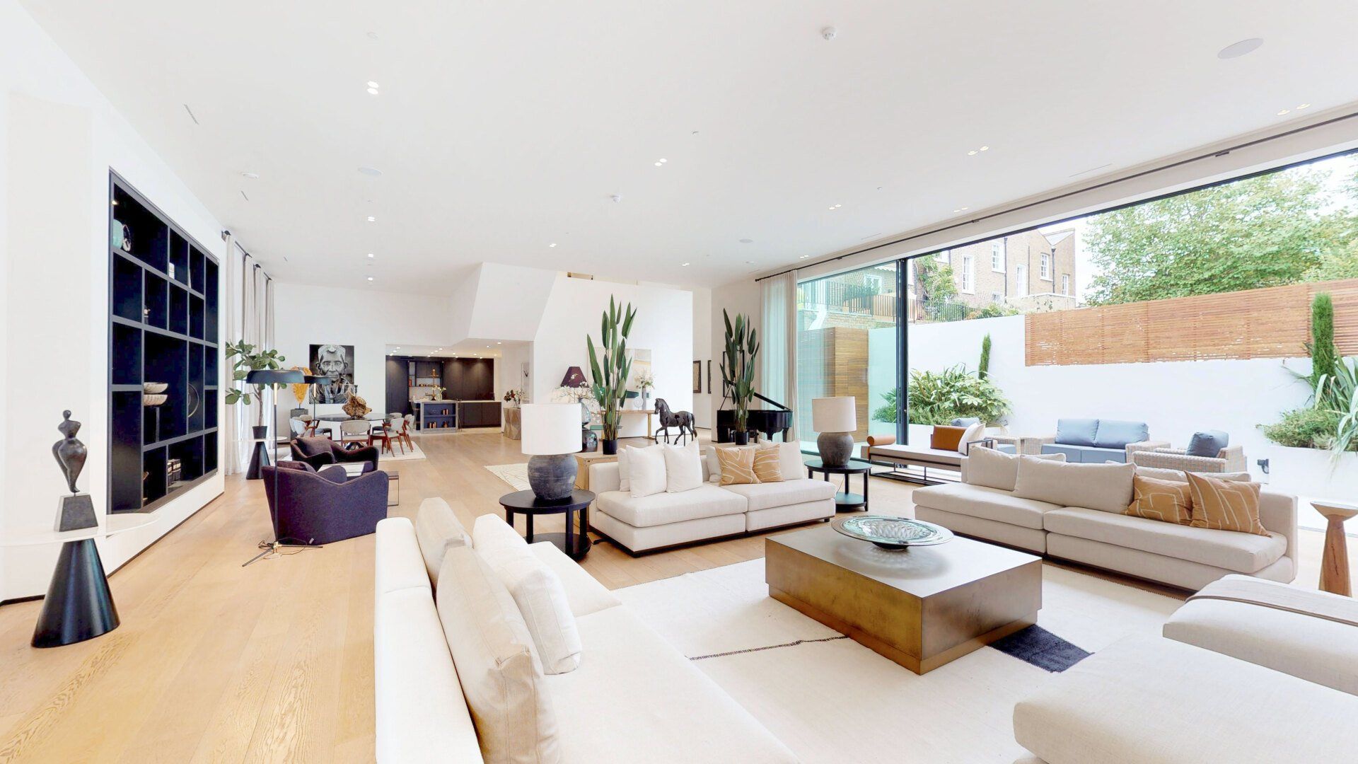 A living room filled with furniture and a large window.