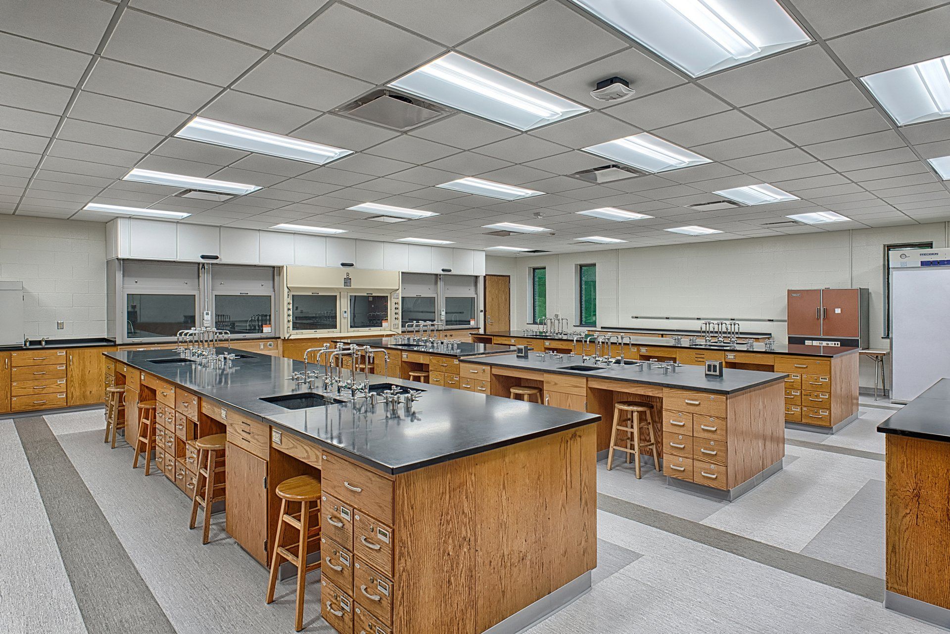 A large classroom with a lot of tables and stools