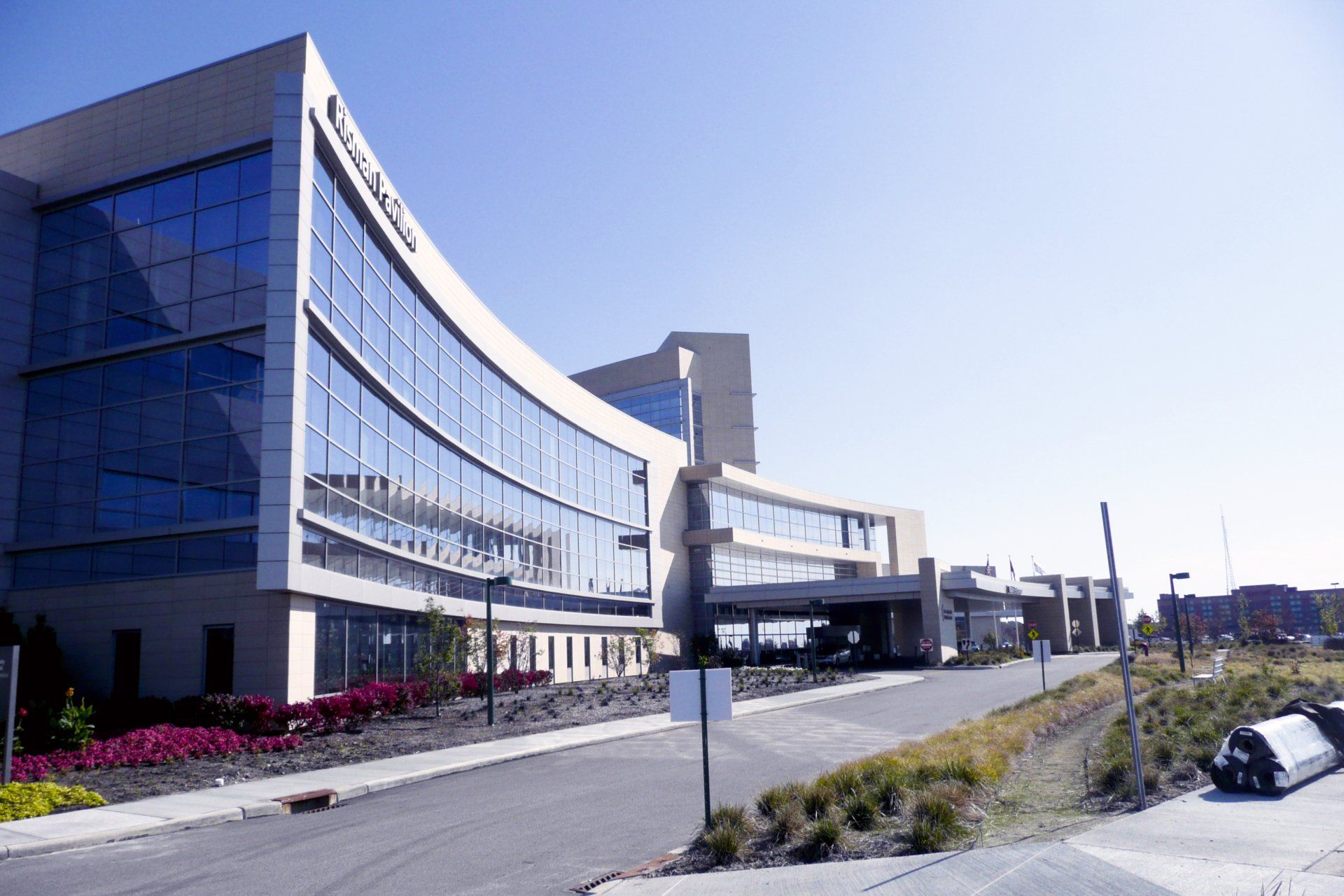 A large building with a lot of windows and a car parked in front of it