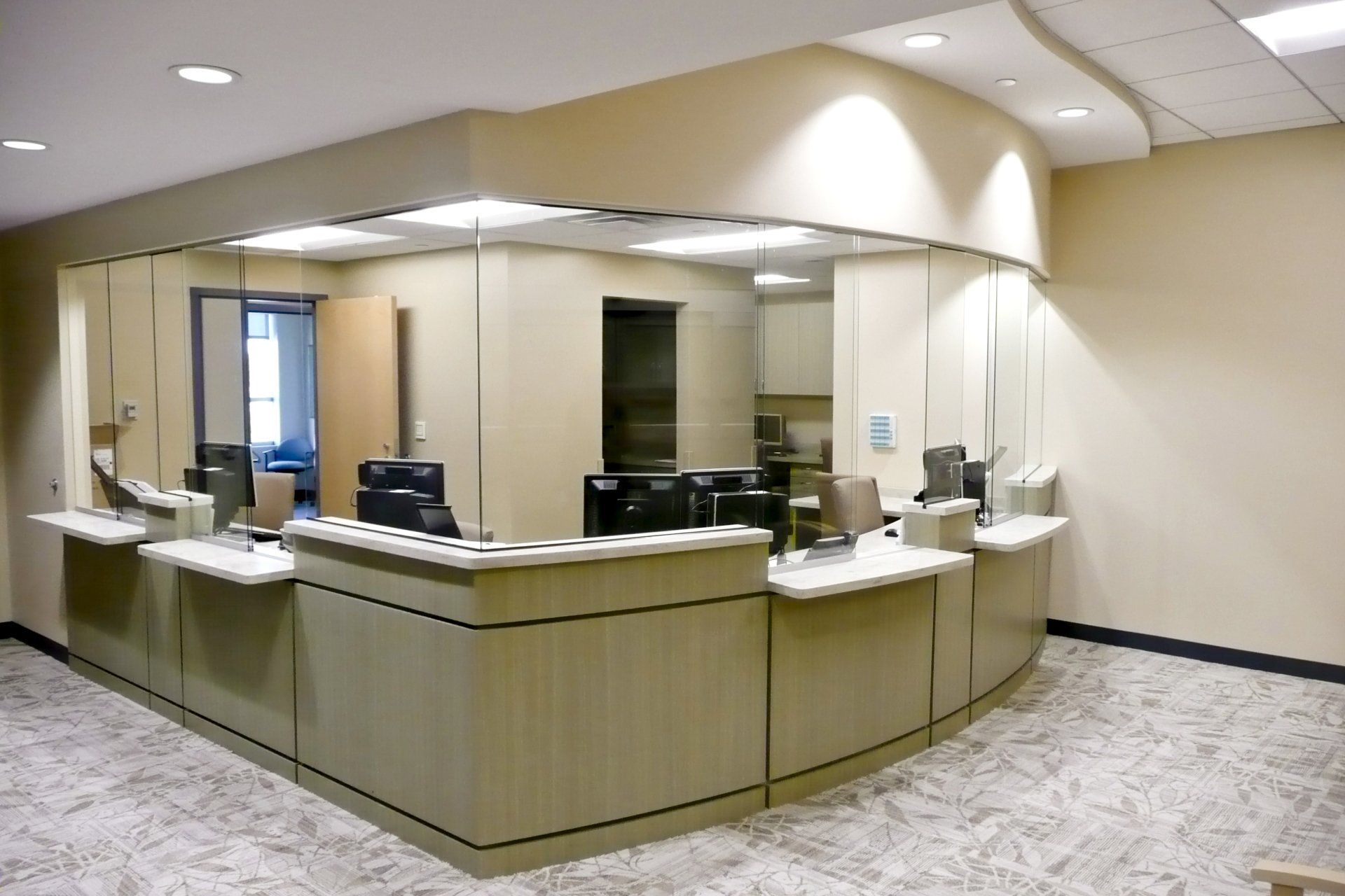 A hospital reception area with a curved counter