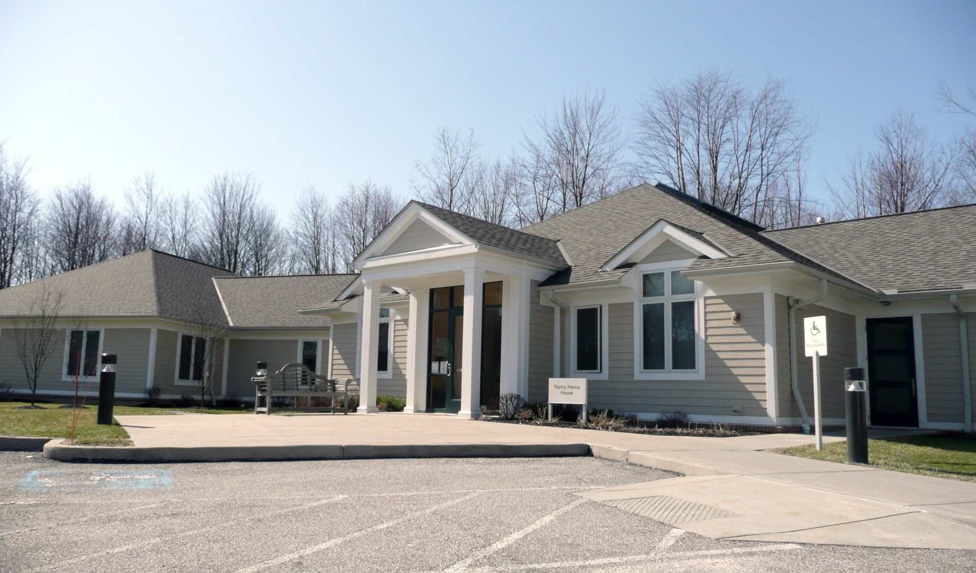 A large house with a parking lot in front of it