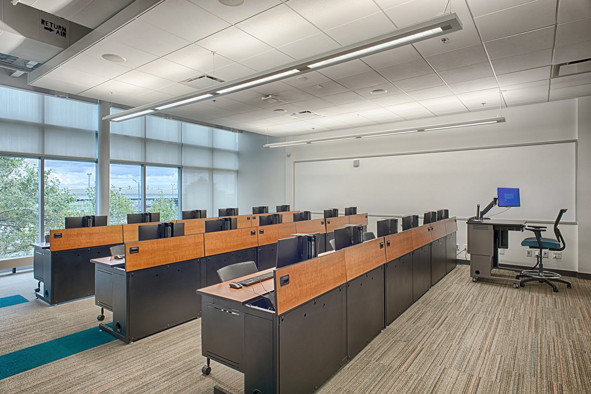 A large classroom with a lot of desks and computers