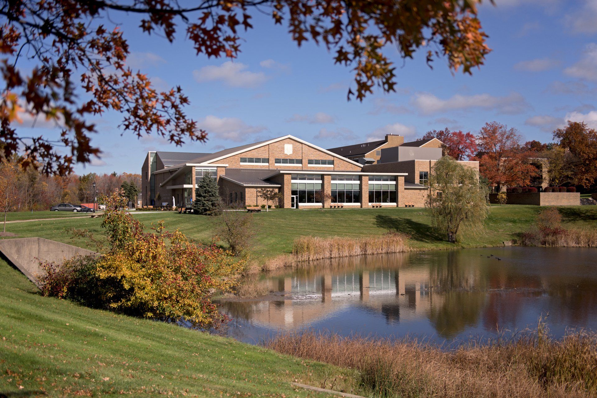 A large building with a pond in front of it