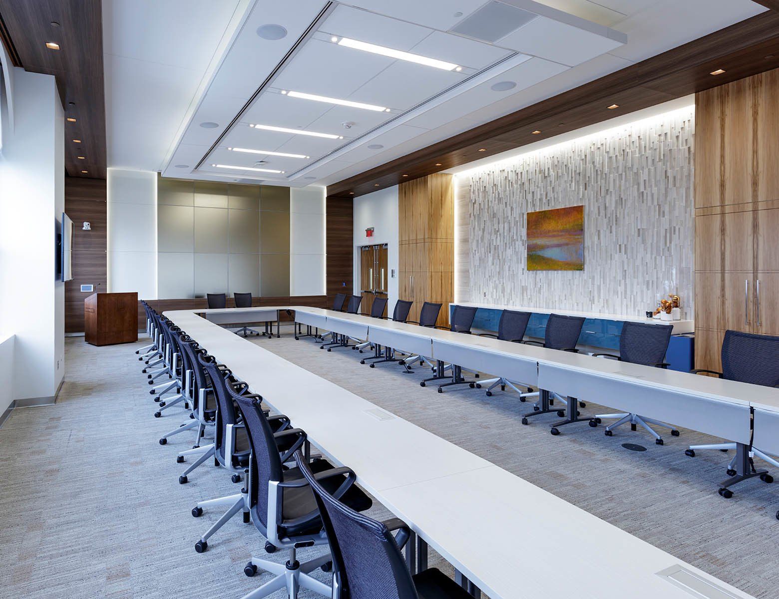 A large conference room with long tables and chairs