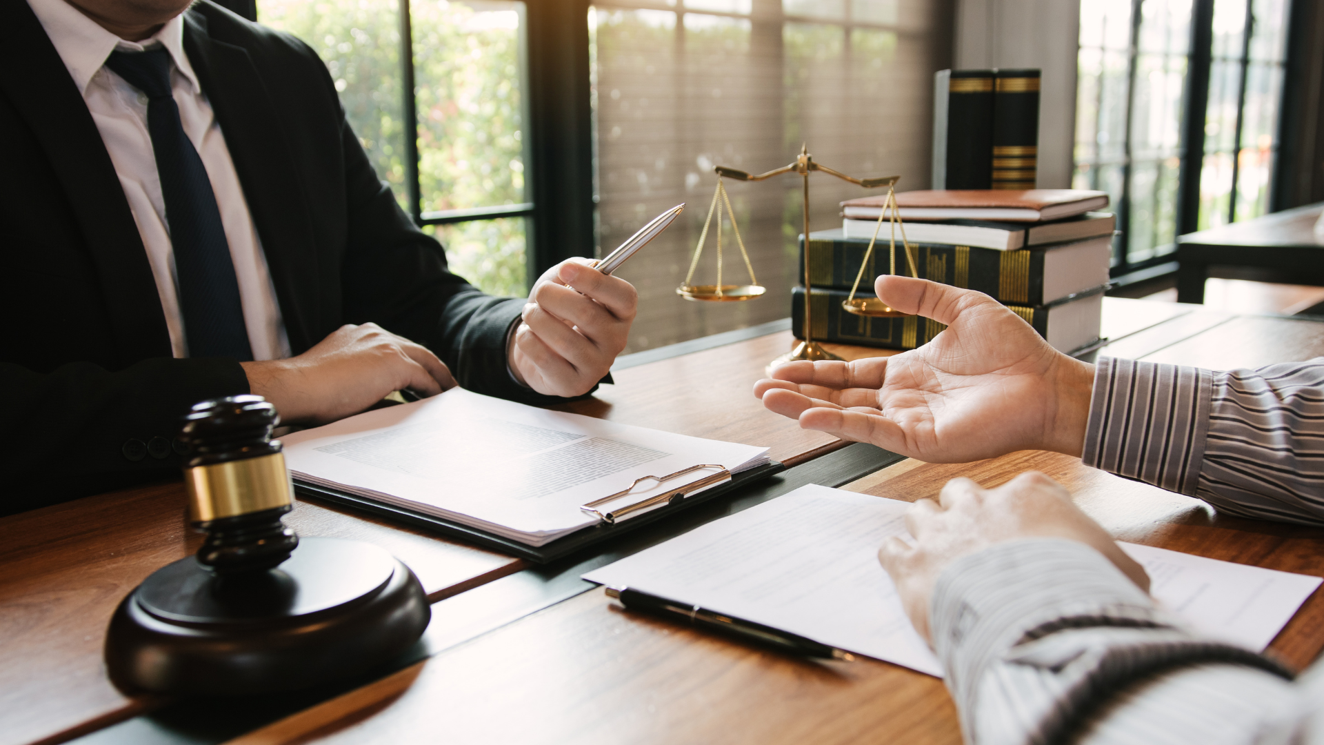 A lawyer is sitting at a table talking to a client.