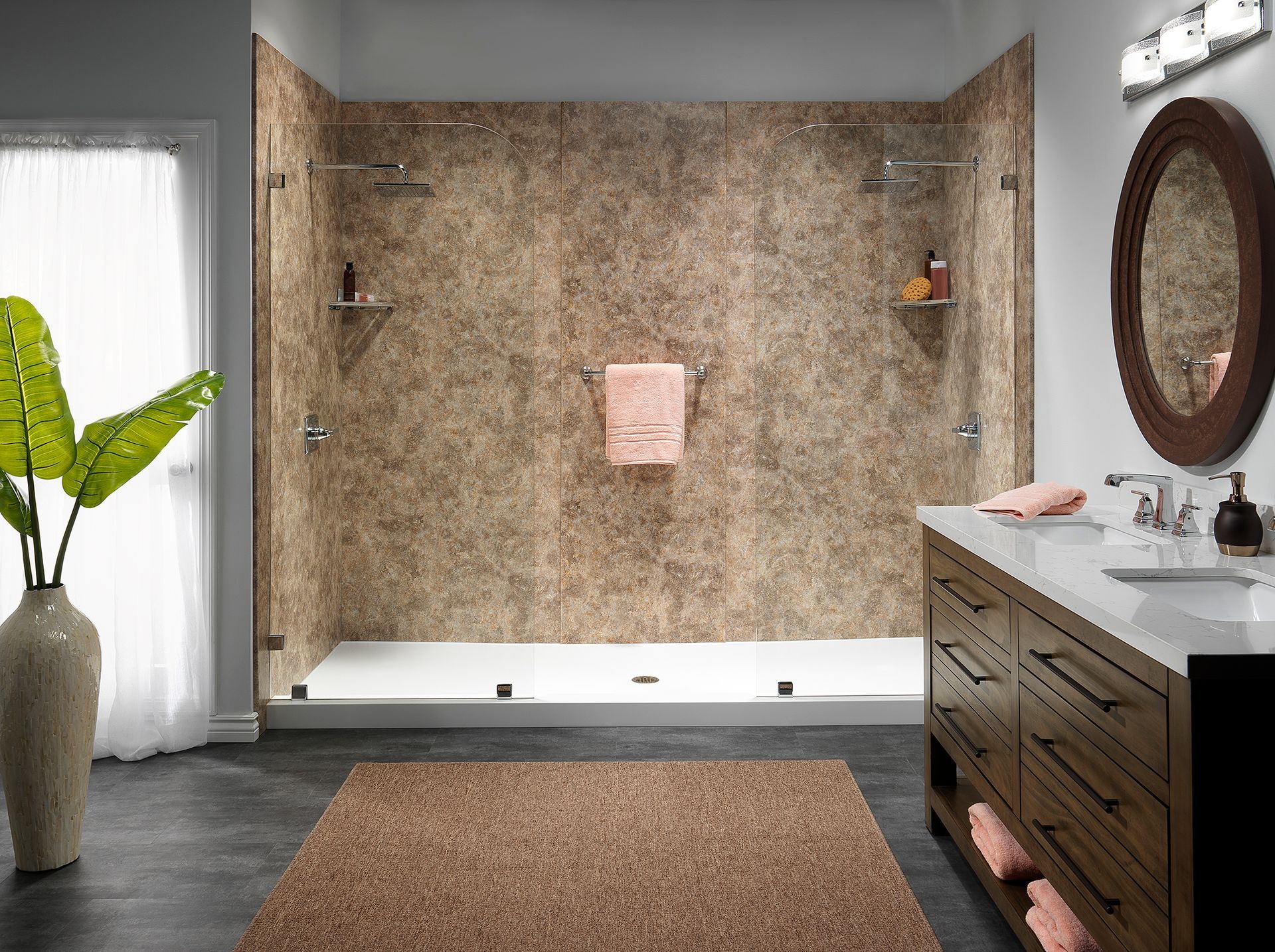 Bathroom with stone-like shower surround, vanity, rug, and window. Warm colors; modern design.