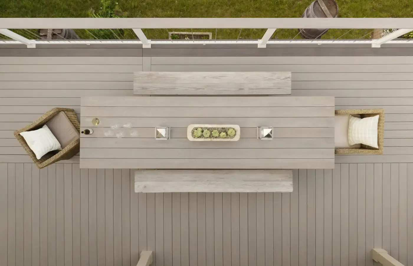 Overhead view of a deck with a table, benches, chairs, and decorative elements.