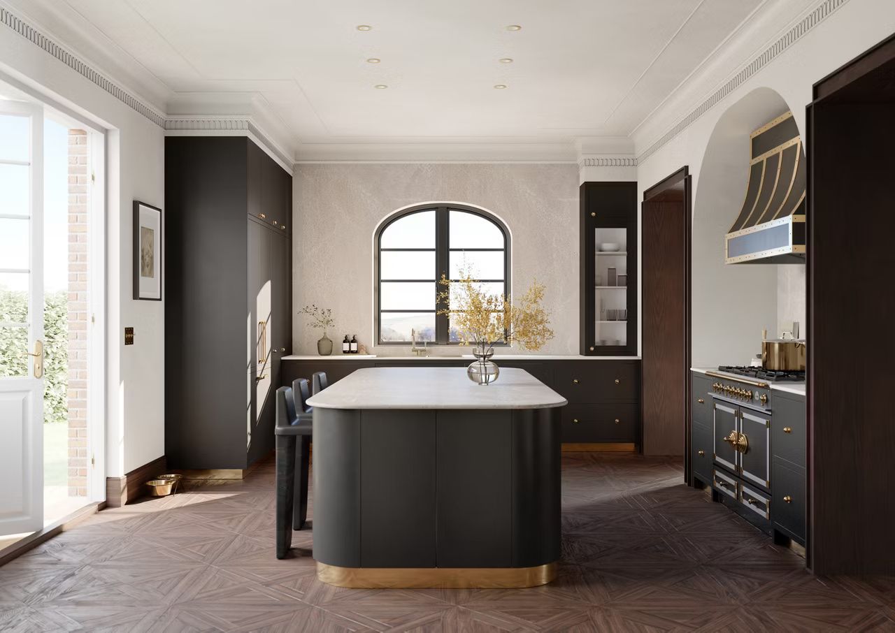 Elegant black and gold kitchen with island, cabinets, arched window, and hardwood floors.