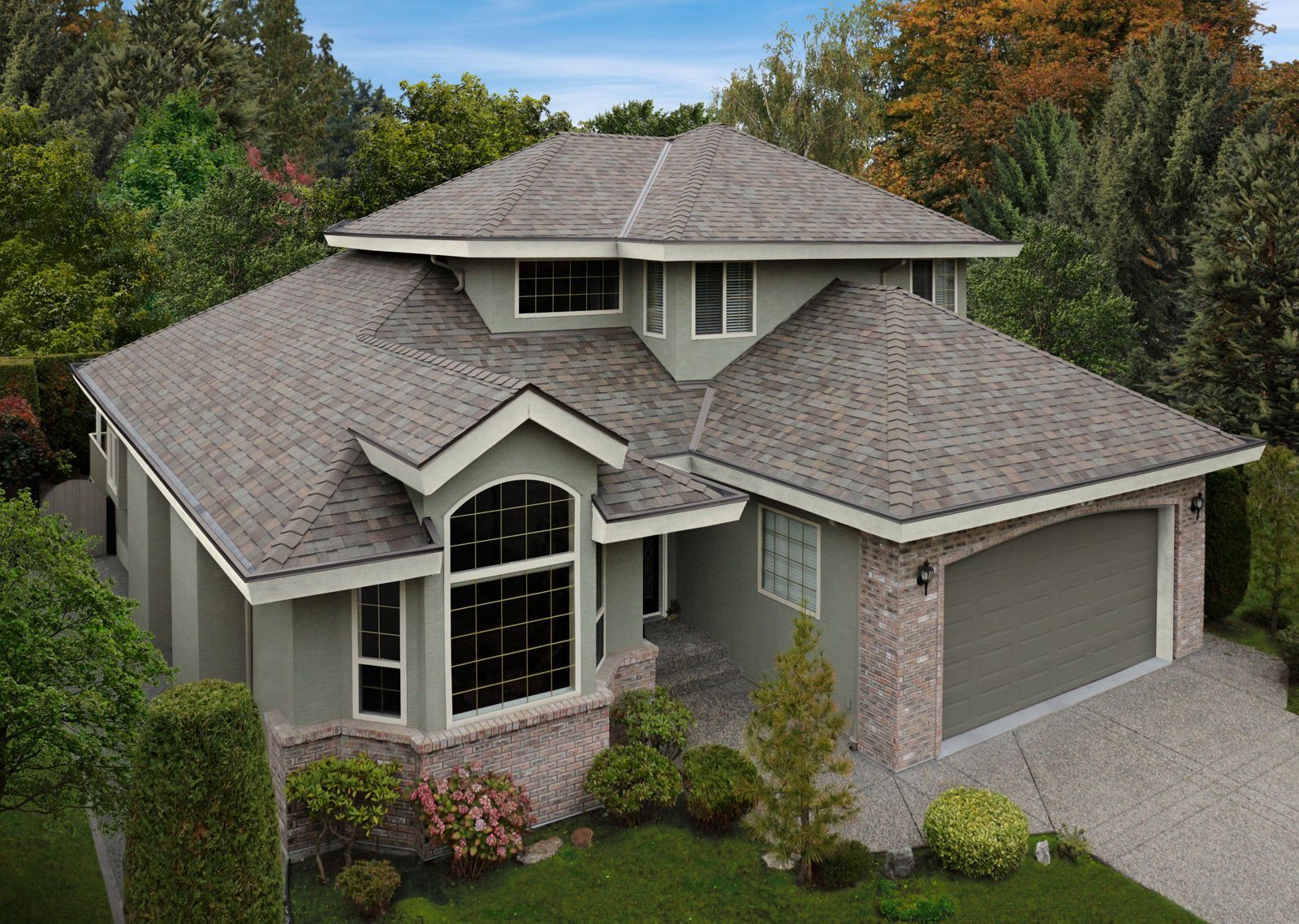 Two-story house with gray roof, light green siding, and a stone garage.