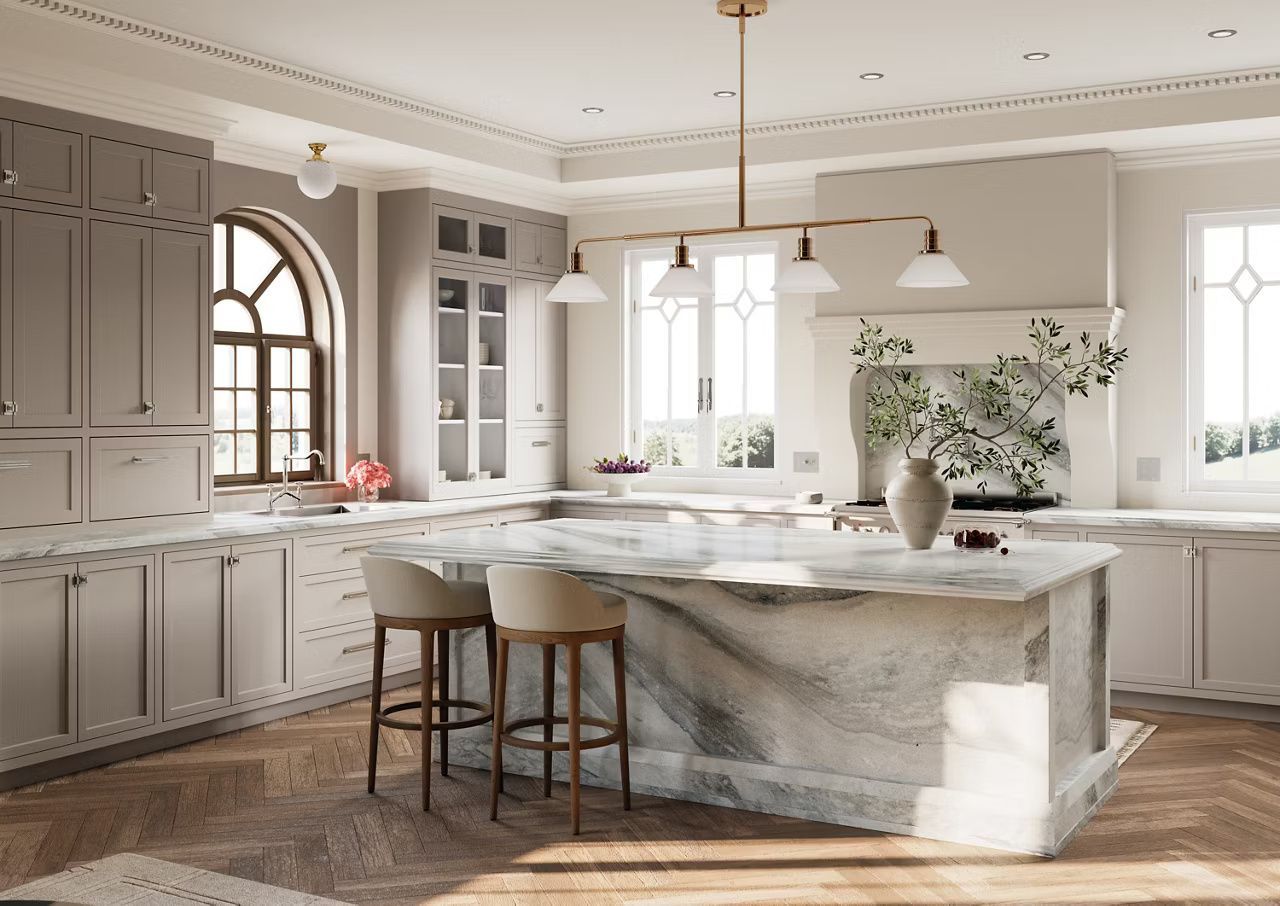 Elegant kitchen with marble island, cabinets, and hardwood floors; beige and gold tones.