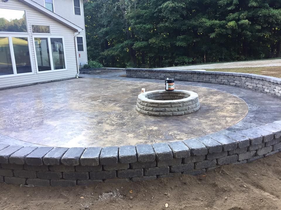 There is a fire pit in the middle of the patio.