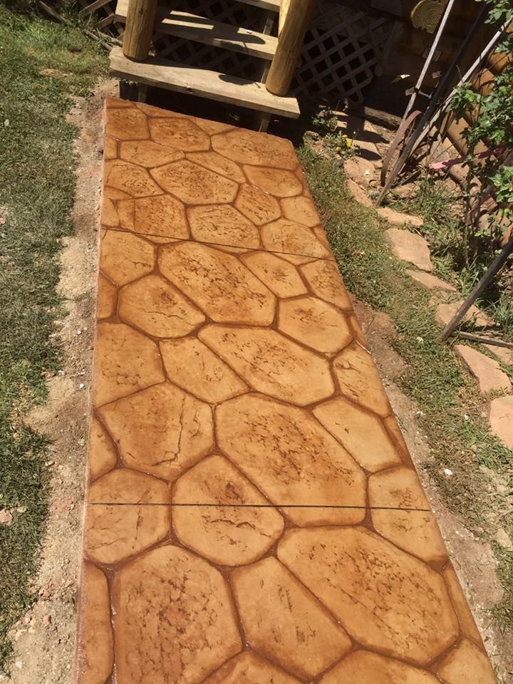 A concrete walkway with a geometric pattern painted on it.