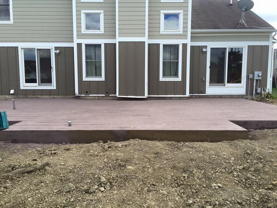 A large house with a patio in front of it.