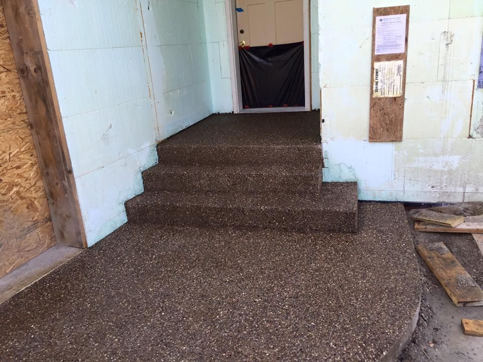 A set of stairs leading up to a doorway in a building.