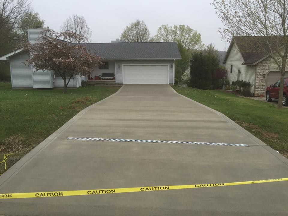 A concrete driveway with a caution tape on it