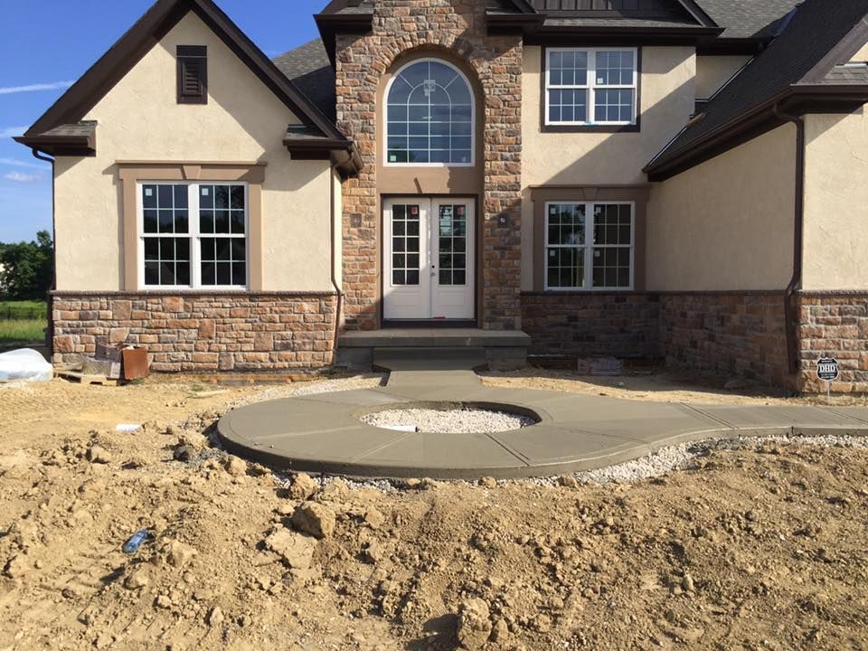A house with a fire pit in front of it