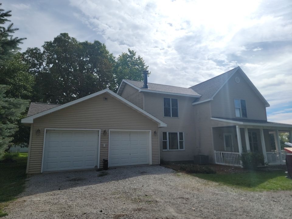 A large house with a garage and a porch.