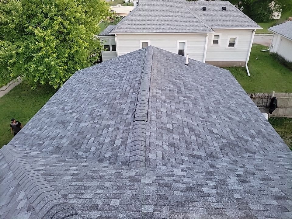 An aerial view of a roof of a house with a gray shingle roof.