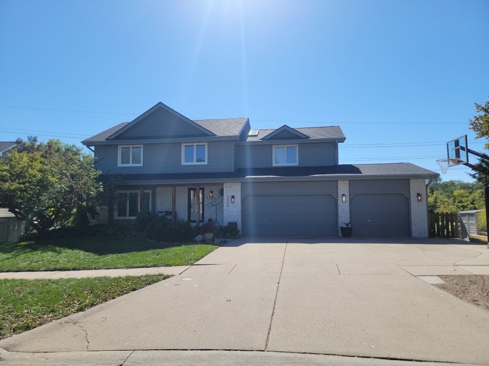 A large house with a basketball hoop in front of it.