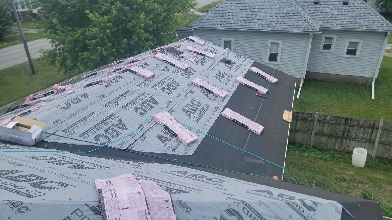 An aerial view of a roof being installed on a house.