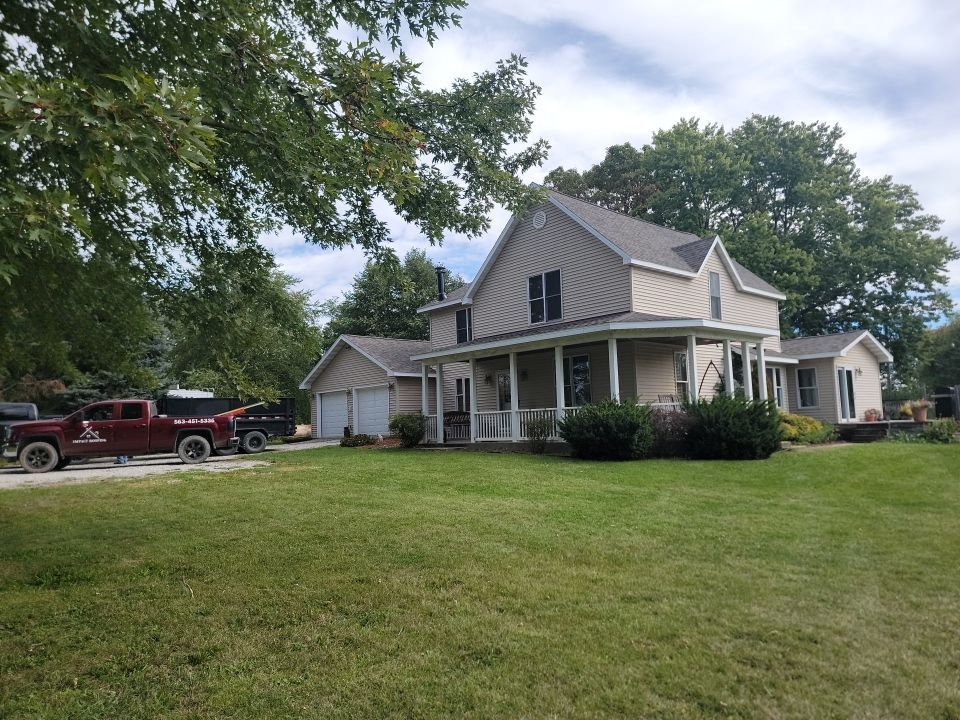 A large house with a red truck parked in front of it.