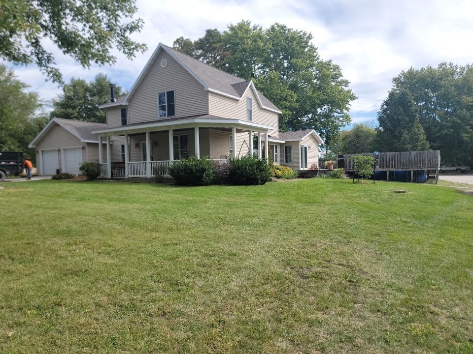 A large house with a large lawn in front of it