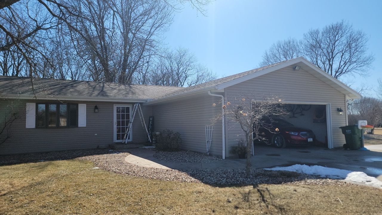 A house with a garage and a car parked in it.