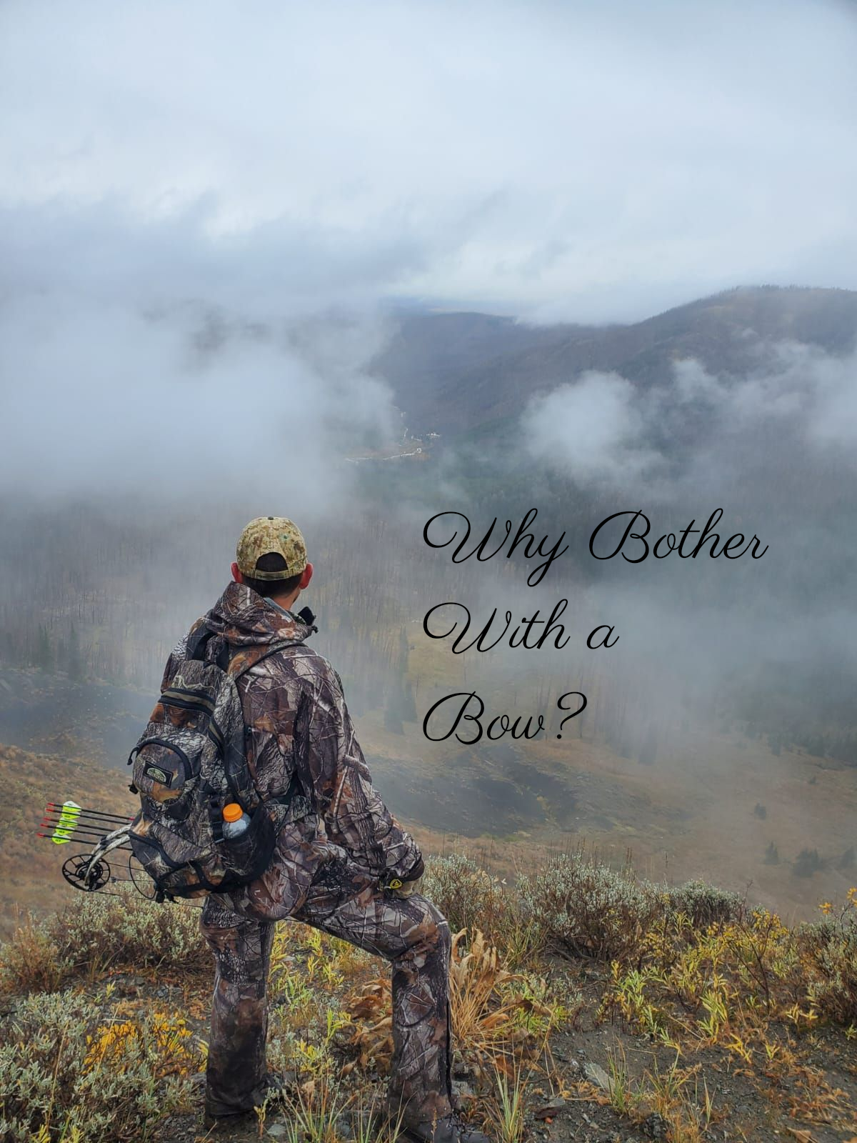 Archery elk hunter in camouflage overlooks a cloudy mountain vista with a bow and backpack.