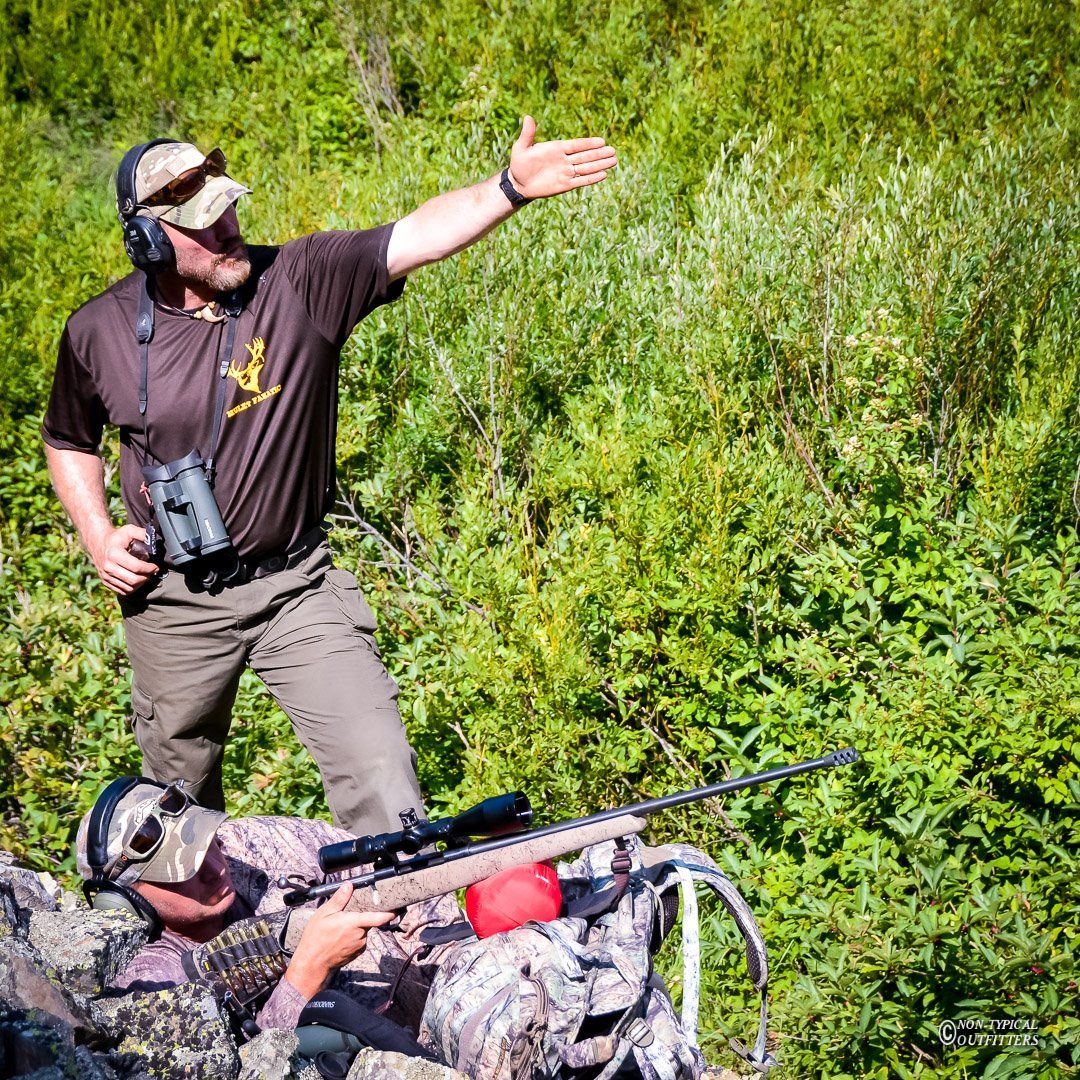 A man in a brown shirt with the letter j on it