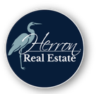 Herron Real Estate logo: blue heron, navy circle, white text.