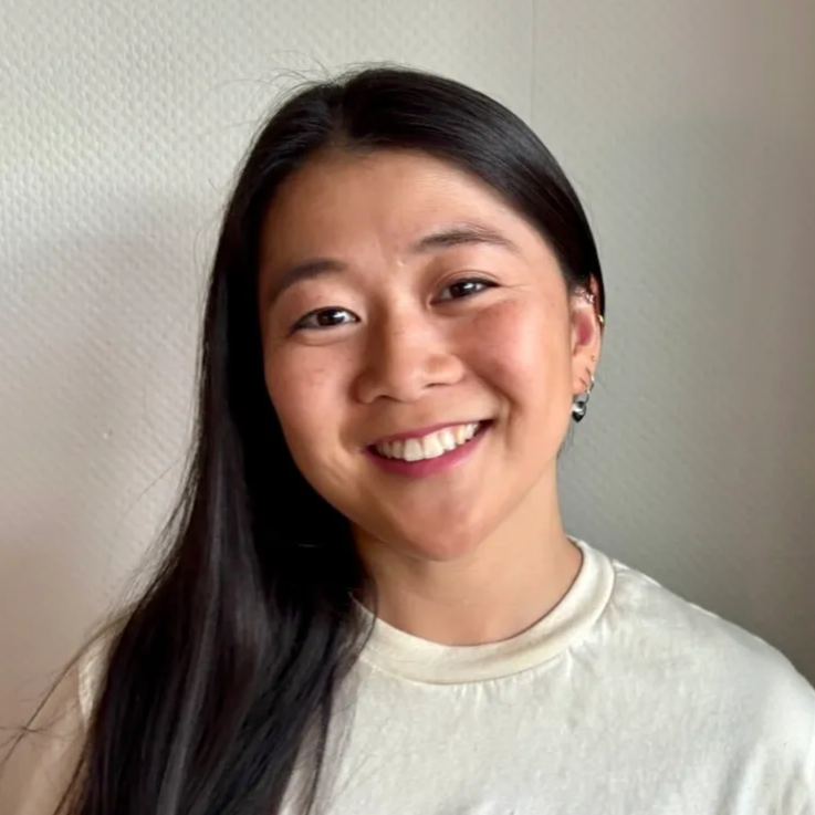 Woman with long brown hair, smiling slightly, looking directly at the camera.