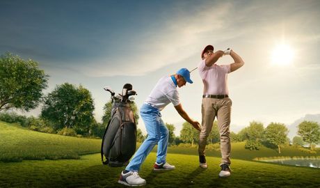 Trainer guiding a golfer
