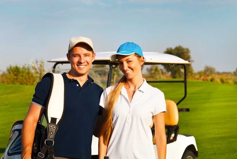 Two golfers smiling