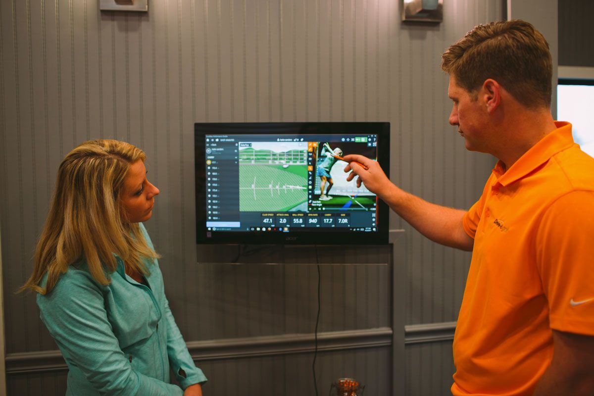 Troy reviewing student's swing