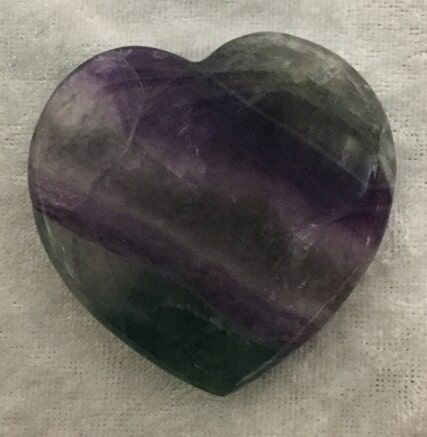 A Heart-Shaped Stone Displaying Vibrant Purple and Green Hues — Crystal Cauldron In South Mackay, QLD
