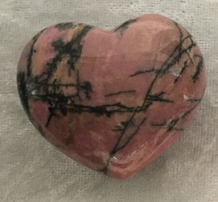 A Turquoise Heart-Shaped Stone Resting on A White Cloth — Crystal Cauldron In South Mackay, QLD
