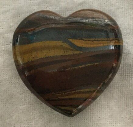 A Heart-Shaped Stone Featuring a Unique Pattern of Brown, Yellow, and Blue Stripes — Crystal Cauldron In South Mackay, QLD
