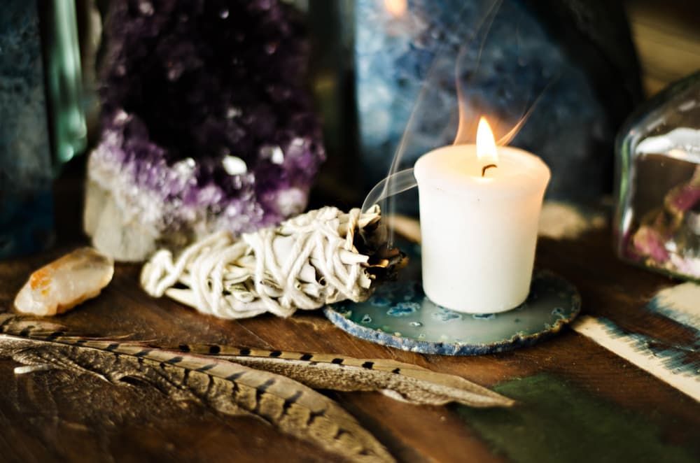 A White Candle Is Sitting on A Wooden Table — Crystal Cauldron in South Mackay, QLD