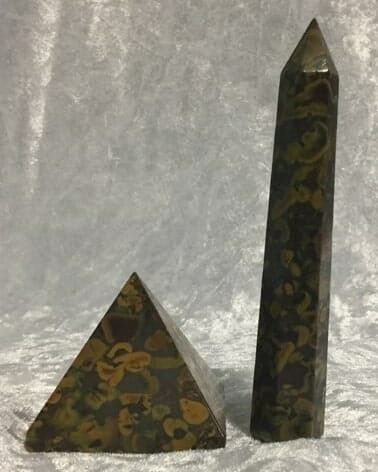 Two Small Pyramid-Shaped Rocks Resting on A Green Marble Base — Crystal Cauldron In South Mackay, QLD